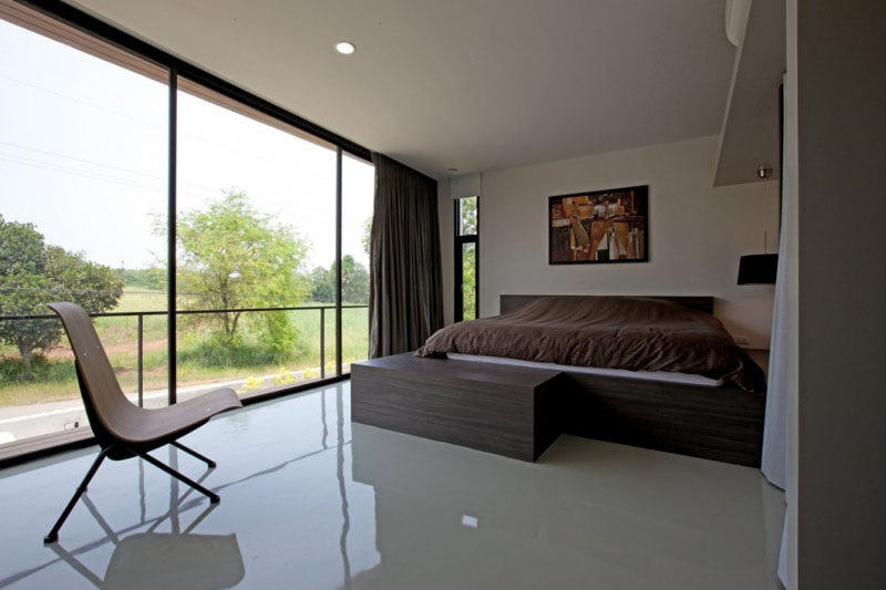 Large floor-to-ceiling windows provide plenty of light to this bedroom.