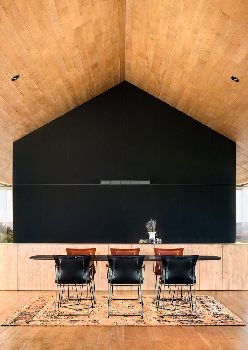 A black feature wall makes a dramatic statement in this dining area.