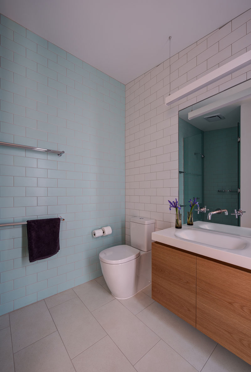 Light blue and white subway tiles cover the walls in this bathroom.