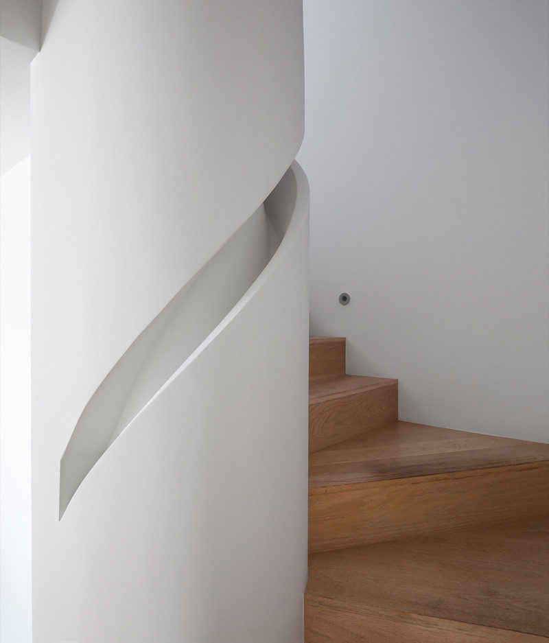 Stair Design Idea - 9 Examples Of Built-In Handrails // A custom handrail has been built into the column that this staircase wraps around.