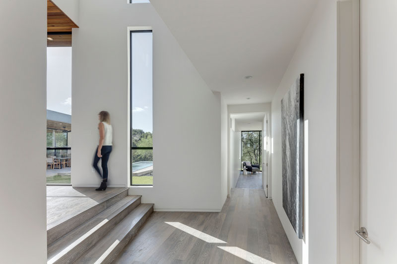 Light wood flooring has been used throughout this home and contrasts the white walls.