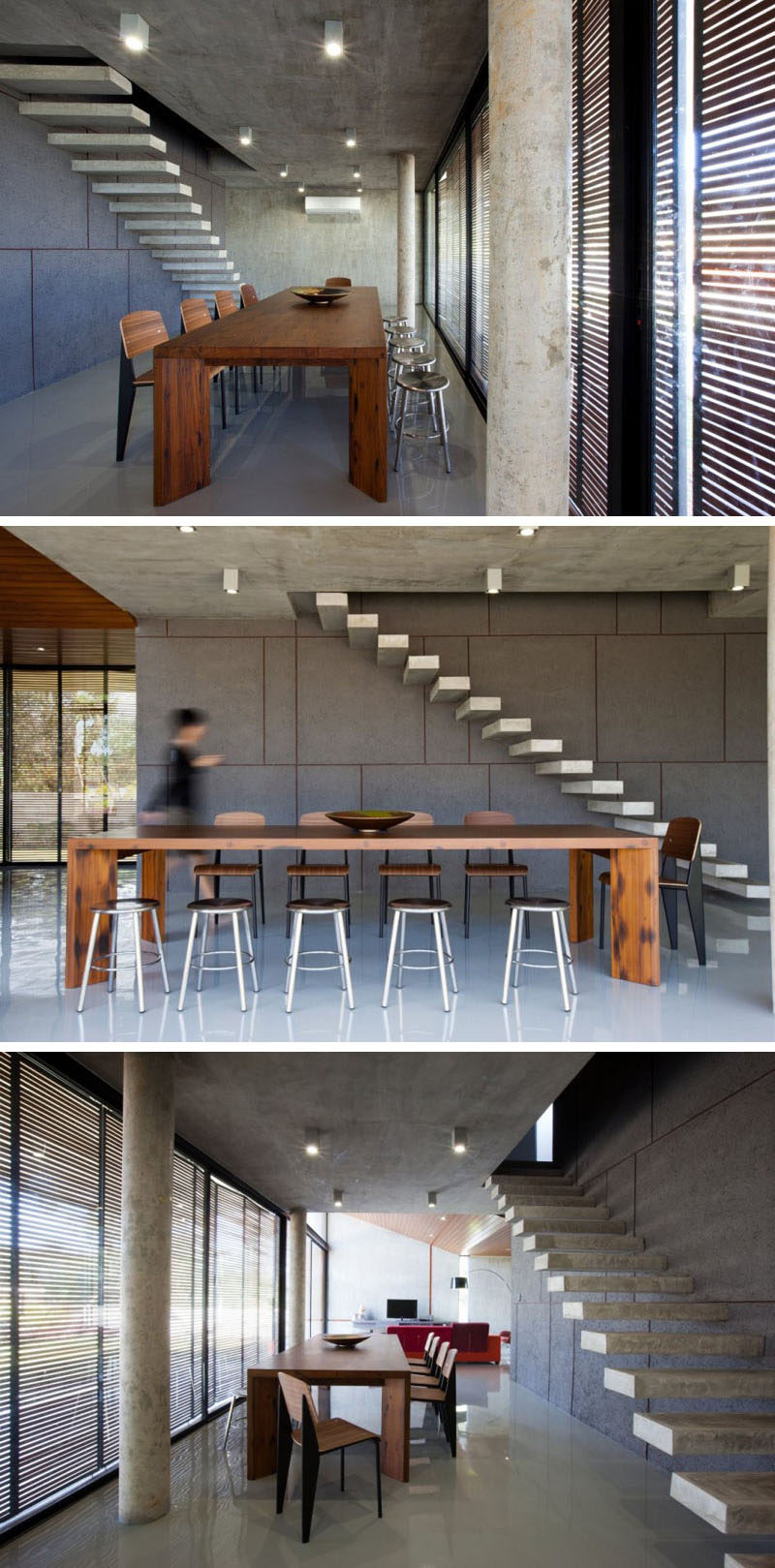 A large wooden dining table and chairs warm up the mostly-concrete interior of this home.