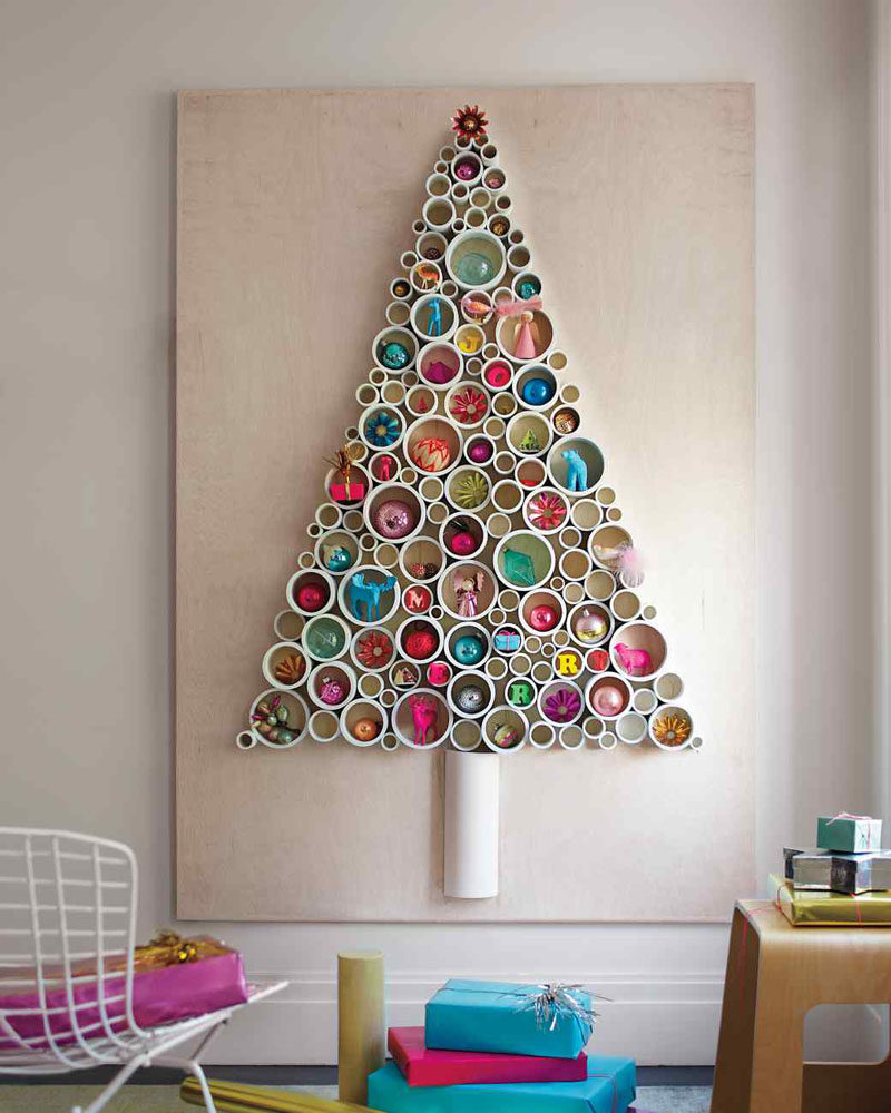 Christmas Decor Ideas - 14 DIY Alternative Modern Christmas Trees // Thin slices of PVC pipe have been attached to a sheet of plywood and filled with fun ornaments to create a festive Christmas tree alternative that can be used year after year.