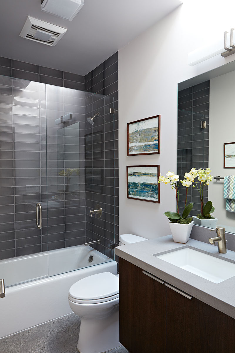 Grey subway tiles have been used for this bathtub and shower surround.