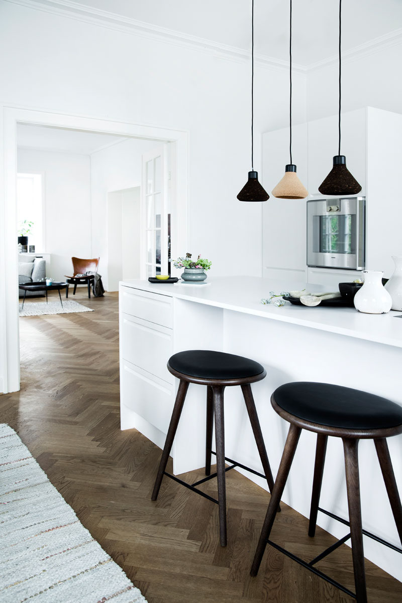 16 Inspirational Pictures Of Herringbone Floors // The dark wood herringbone floor in this apartment warms up the all white interior.