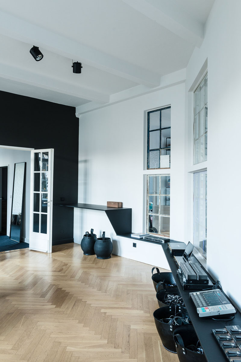 16 Inspirational Pictures Of Herringbone Floors // This studio/loft has light wood herringbone floors to warm up the black and white interior.