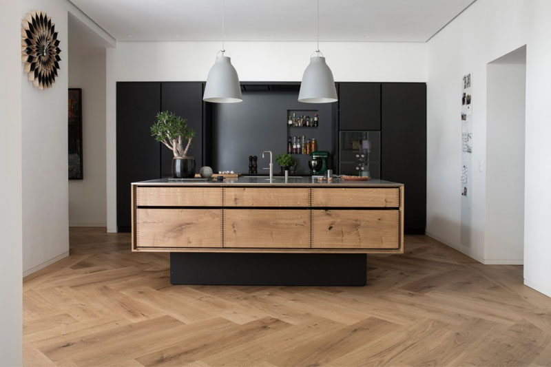 16 Inspirational Pictures Of Herringbone Floors // The herringbone wood floors and wood elements in the island keep this kitchen feeling natural and bright even with the all black cabinetry.