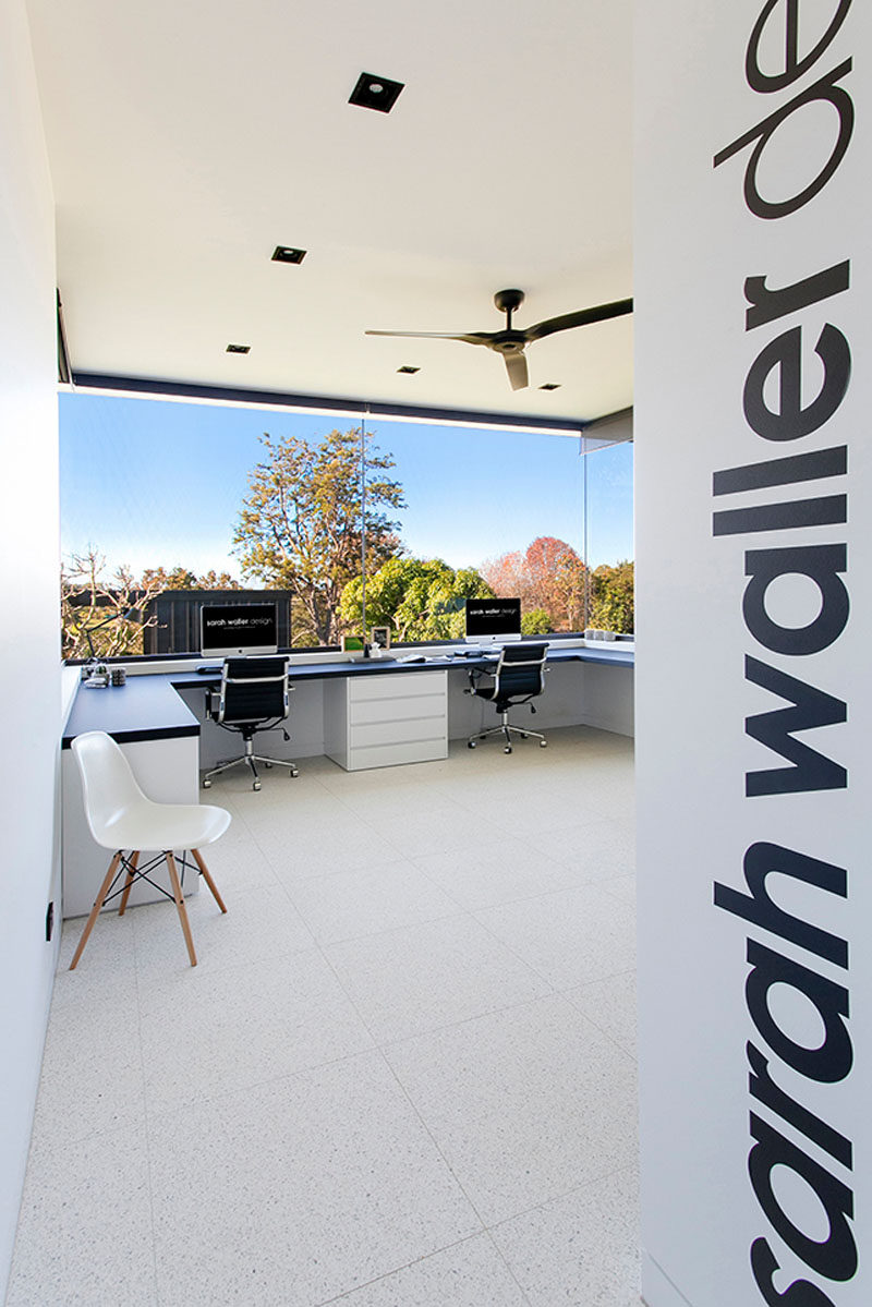 This home office of an architect looks out over the backyard from the wrap around windows.