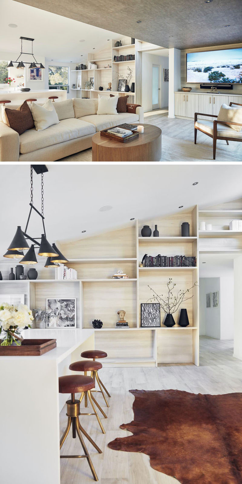 In this home, the main living and kitchen area share the space, with one of the walls covered in light wood shelving, ideal for displaying personal items.