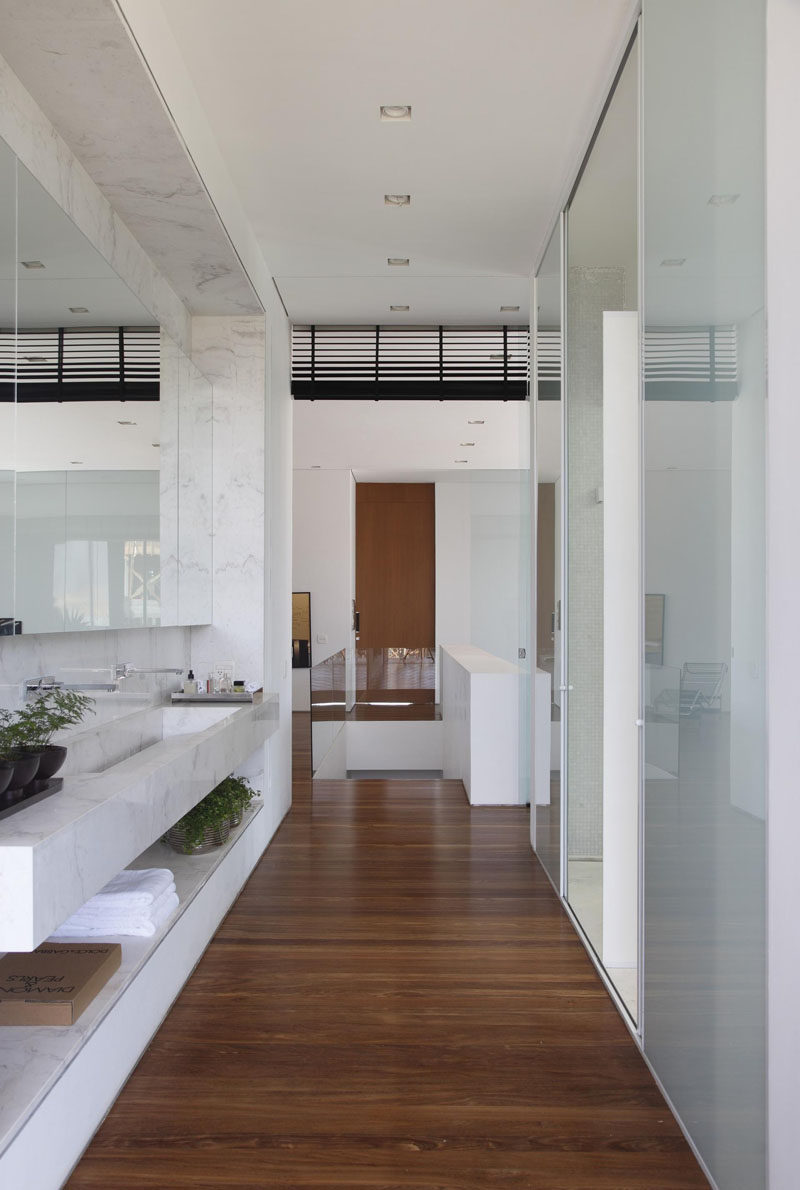 In this bathroom, the color palette has been kept bright and frosted glass doors provide privacy.