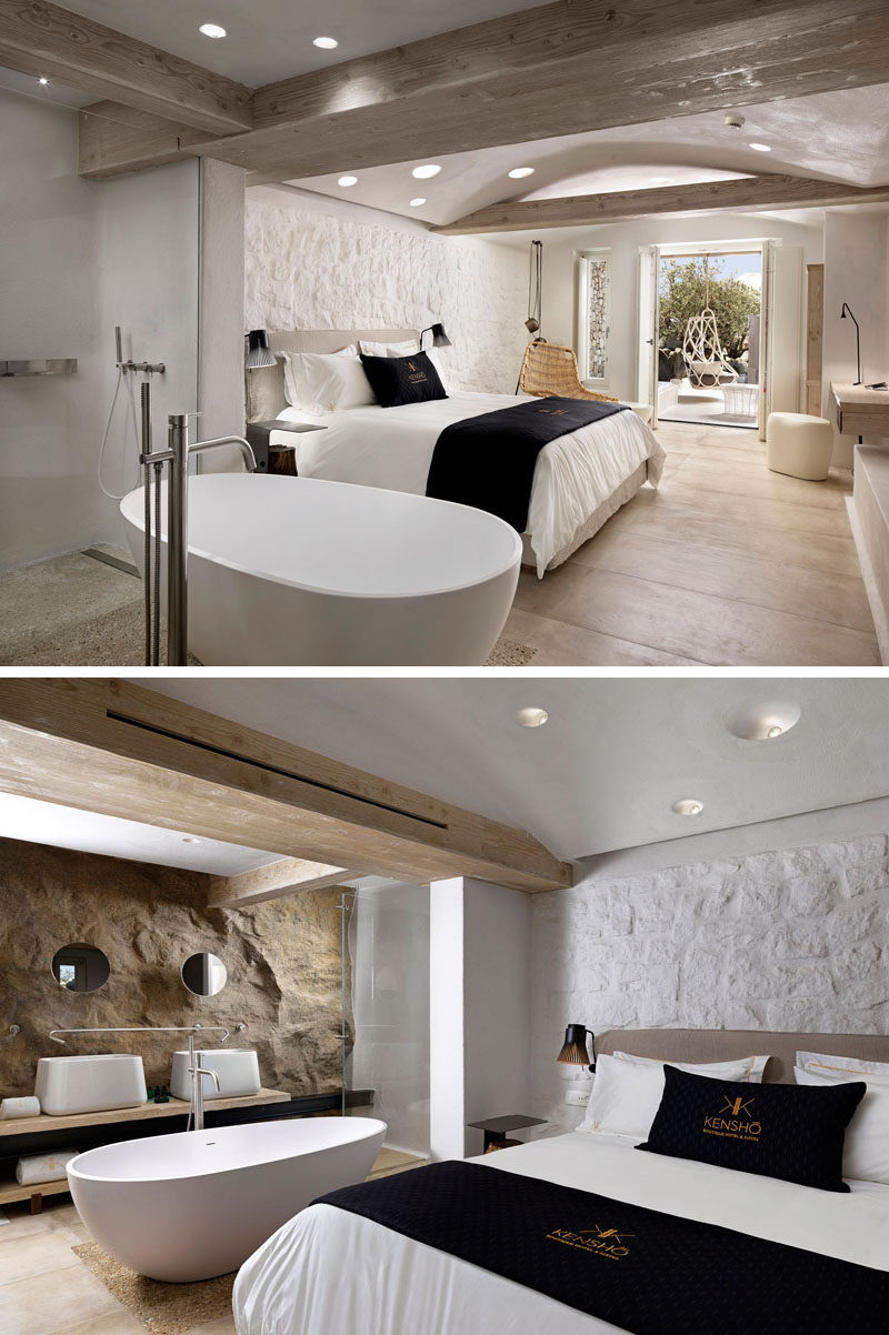 In this hotel room, a natural rock wall appears in the bathroom, while the stone wall behind the bed has been painted white to give the space a more contemporary feel.