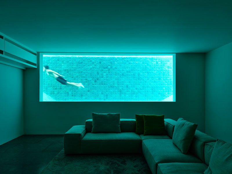 The basement of this home has a window that looks into the pool.