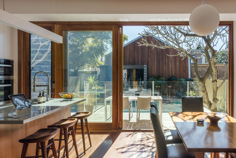 This combined kitchen and dining room open up to a balcony that overlooks the backyard.