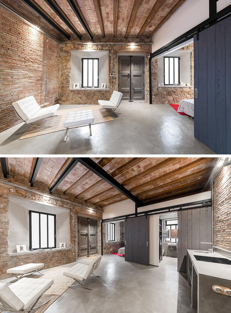 In this renovated workshop, the guest suite / studio space shows off original details like the walls and ceiling, while new details like a concrete floor, barn doors and a bathroom have been included.