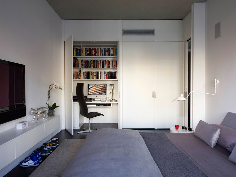 Small Apartment Design Ideas - Create A Home Office In A Closet // While one closet in this bedroom holds clothes the other contains a work space complete with a desk, book shelves, and storage drawers.