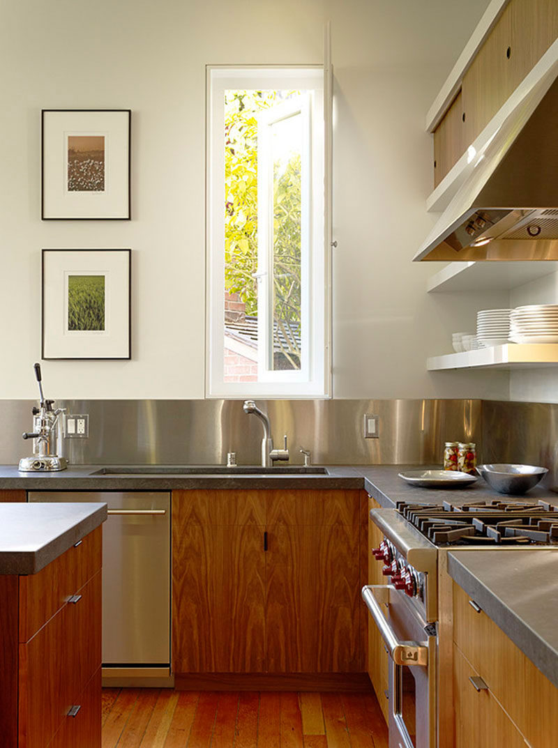 Kitchen Design Idea - Stainless Steel Backsplash // Stainless steel panels wrap around the walls of this kitchen to make for easy clean up after a messy meal.