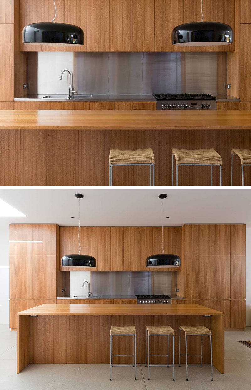Kitchen Design Idea - Stainless Steel Backsplash // The modern stainless steel work top and backsplash contrast the natural look of the wood cabinetry and island in this kitchen.