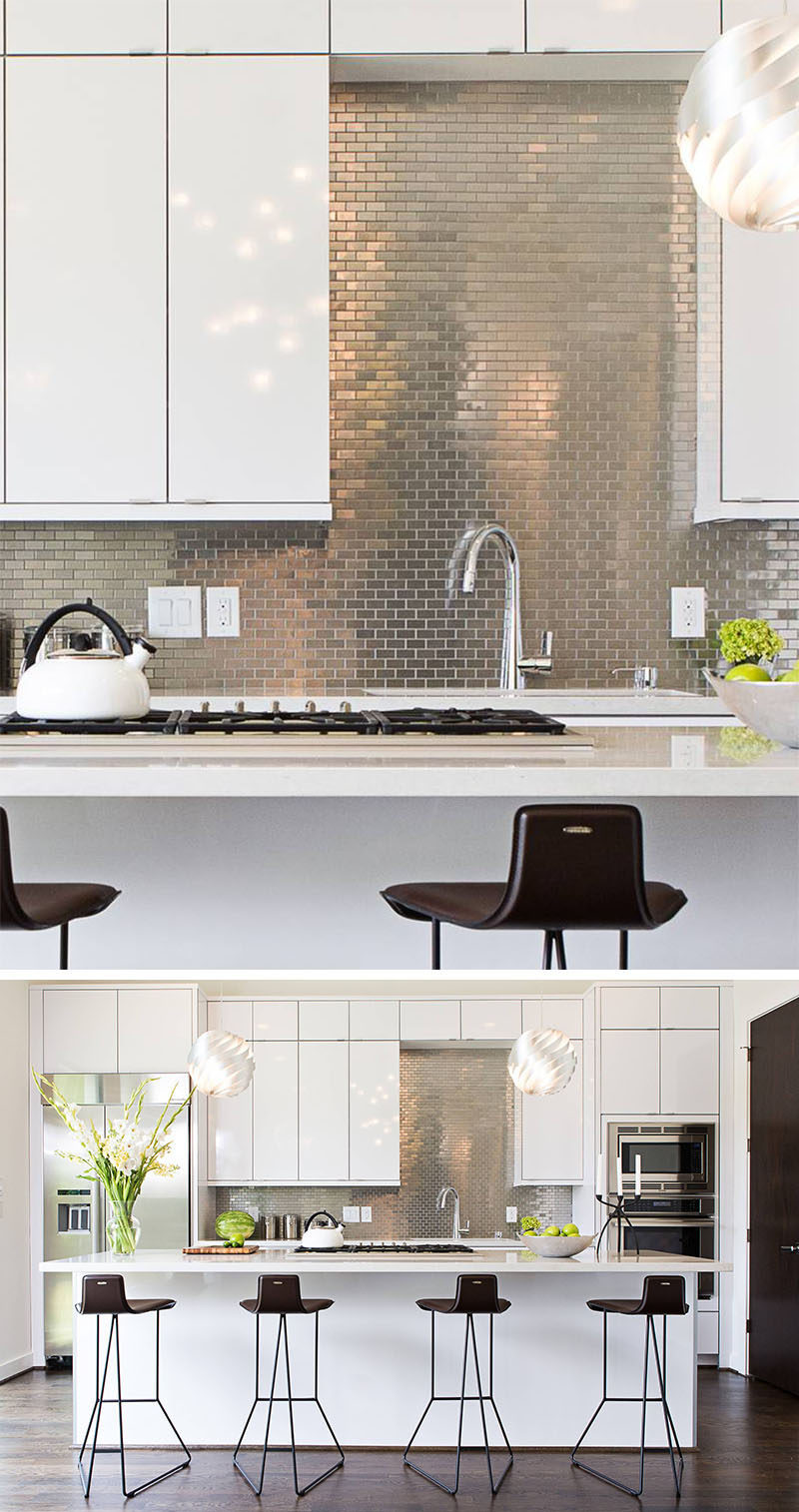 Kitchen Design Idea - Stainless Steel Backsplash // Small stainless steel tiles have been arranged in a brick-like pattern to contrast the white cabinetry and to help brighten the kitchen.
