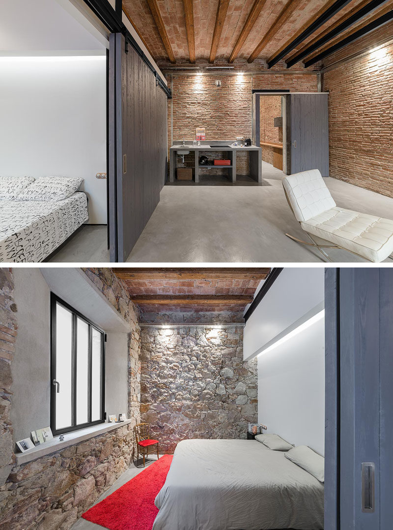 In this renovated apartment, the bedroom has a pristine wall that's a strong contrast with the original stone walls.