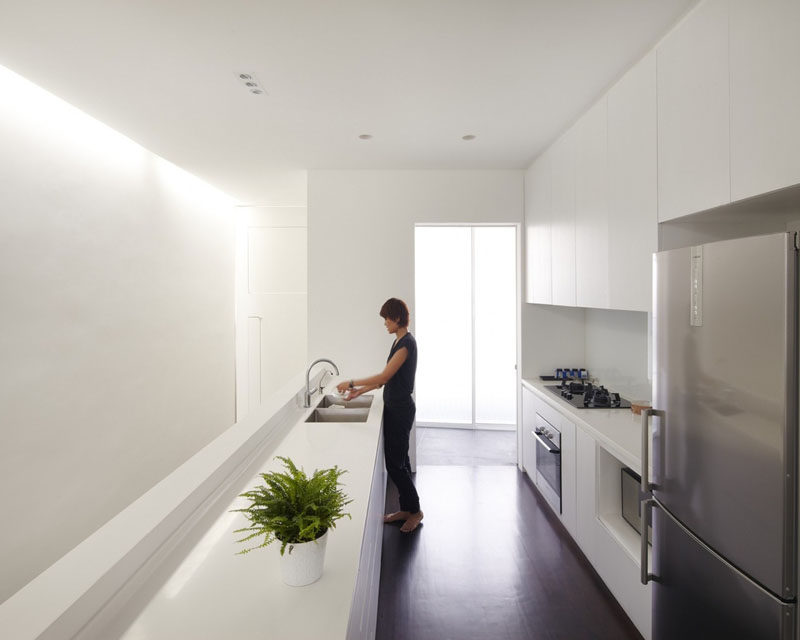 Kitchen Design Ideas - White, Modern and Minimalist Cabinets // This all white kitchen features white handle-less cabinetry to create a smooth streamlined look.