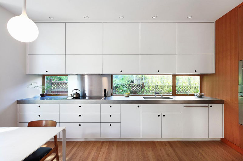 Kitchen Design Ideas - White, Modern and Minimalist Cabinets // Crisp white cabinetry in this kitchen brightens up the wood and creates a more modern look.