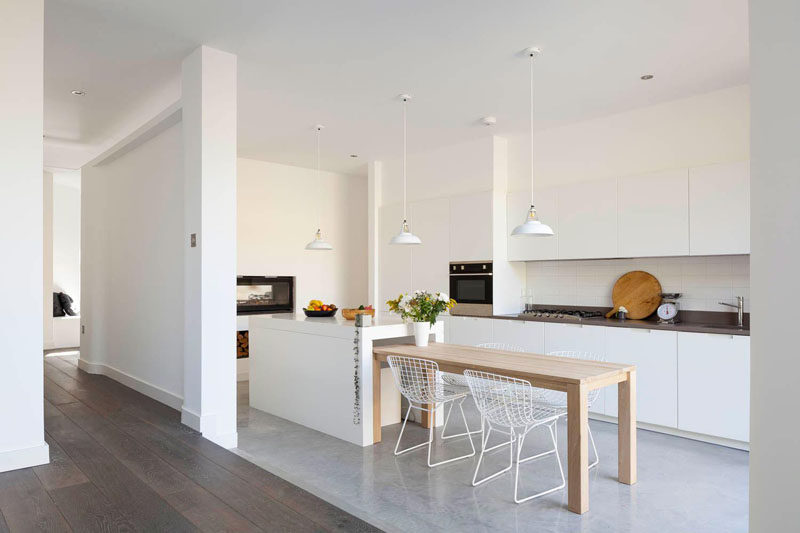 Kitchen Design Ideas - White, Modern and Minimalist Cabinets // The white cabinets in this kitchen appear to blend right into the white walls and create the illusion that they reach up to the ceiling.