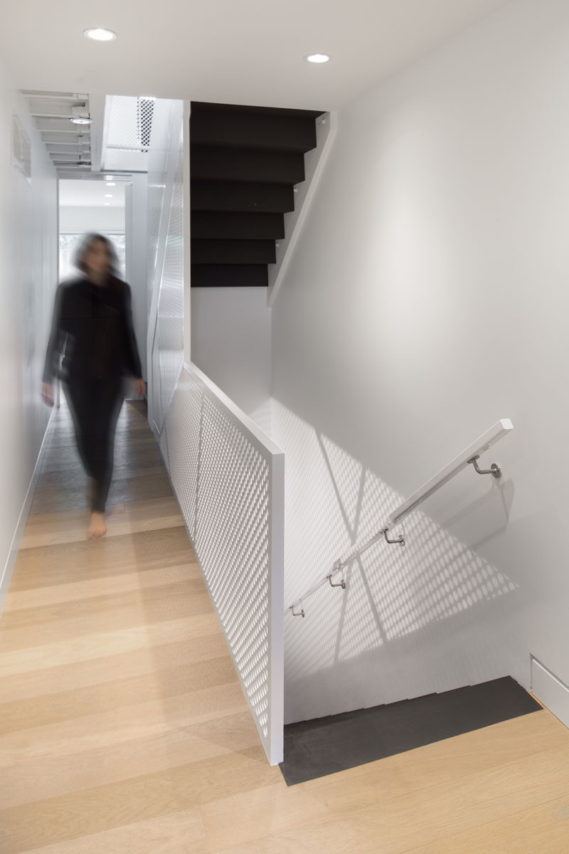 These dark stairs provide a strong contrast to the rest of the bright and light interior.
