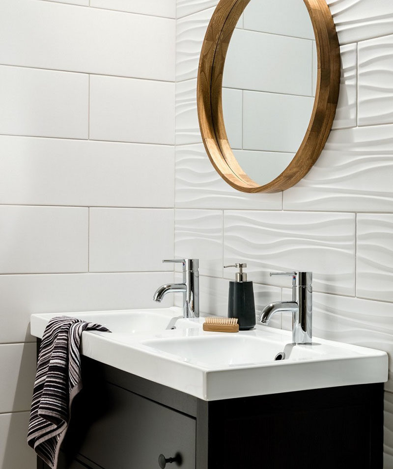 Bathroom Tile Ideas - Install 3D Tiles To Add Texture To Your Bathroom // The ripples in these white bathroom tiles used on one wall add a wave-like look to the wall but are close enough to the style of the flat tiles to make the combination work.