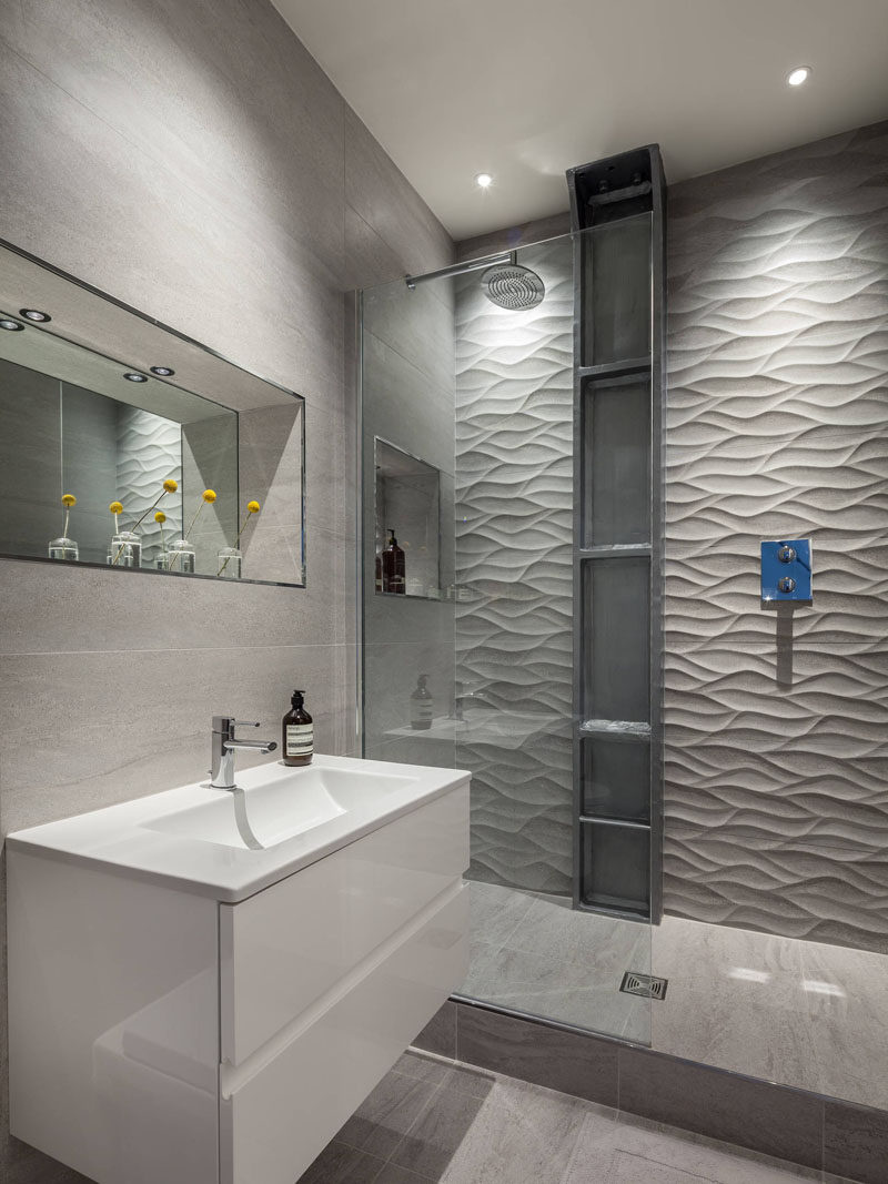 Bathroom Tile Ideas - Install 3D Tiles To Add Texture To Your Bathroom // The wavy pattern of these shower tiles give the bathroom a serene feel and resembles the look of a rippling river or stream.
