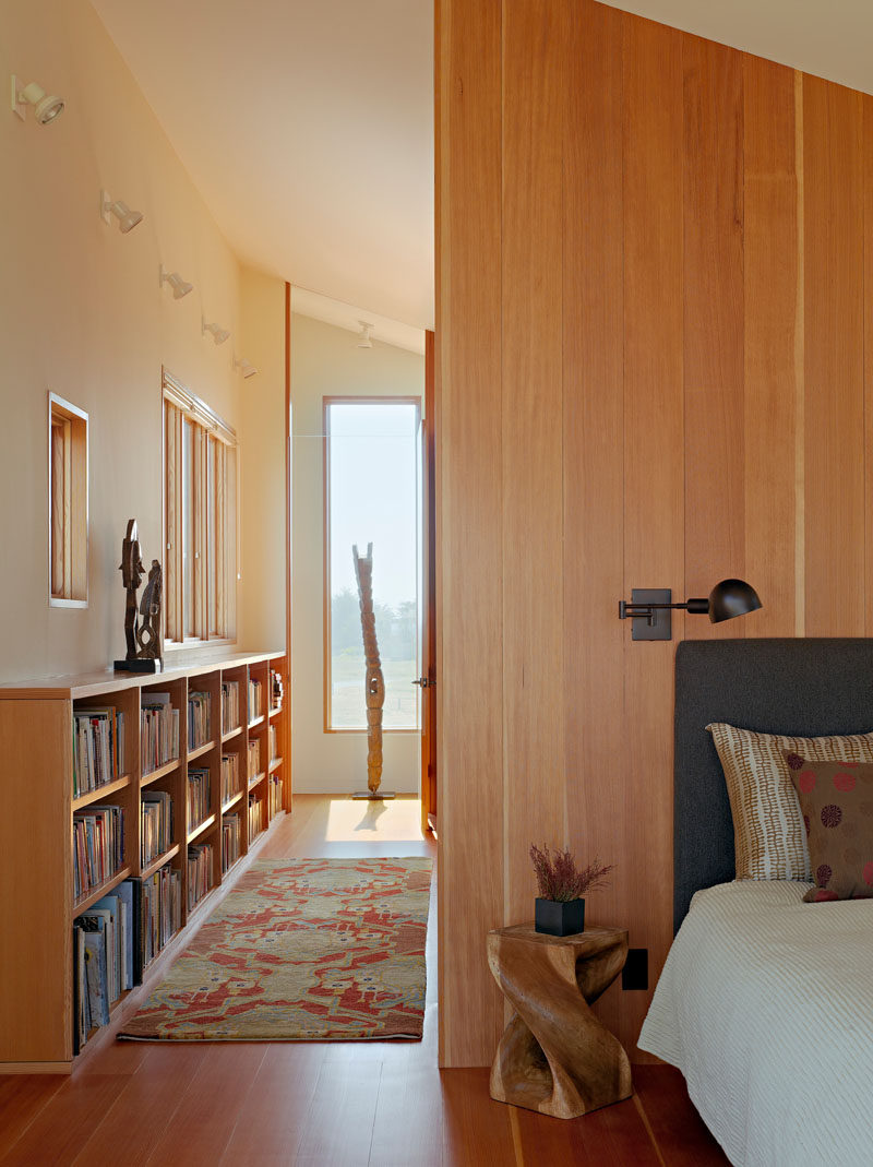 Wooden floors, shelving and walls have been used to create a sense of warmth in this bedroom.