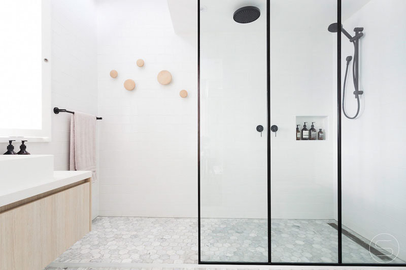 Bathroom Design Ideas - Black Shower Frames // Black frames surround the glass panels of this shower and match the hardware to create a modern looking bathroom with a light/dark contrast.