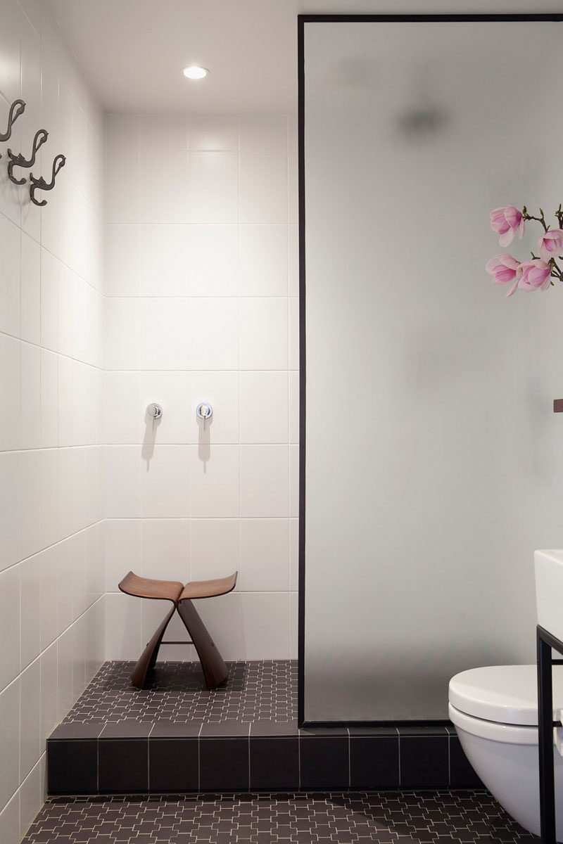 Bathroom Design Ideas - Black Shower Frames // The black frame around the frosted glass door of this shower adds a simple sophistication to the space and ties together the other black elements in the room.