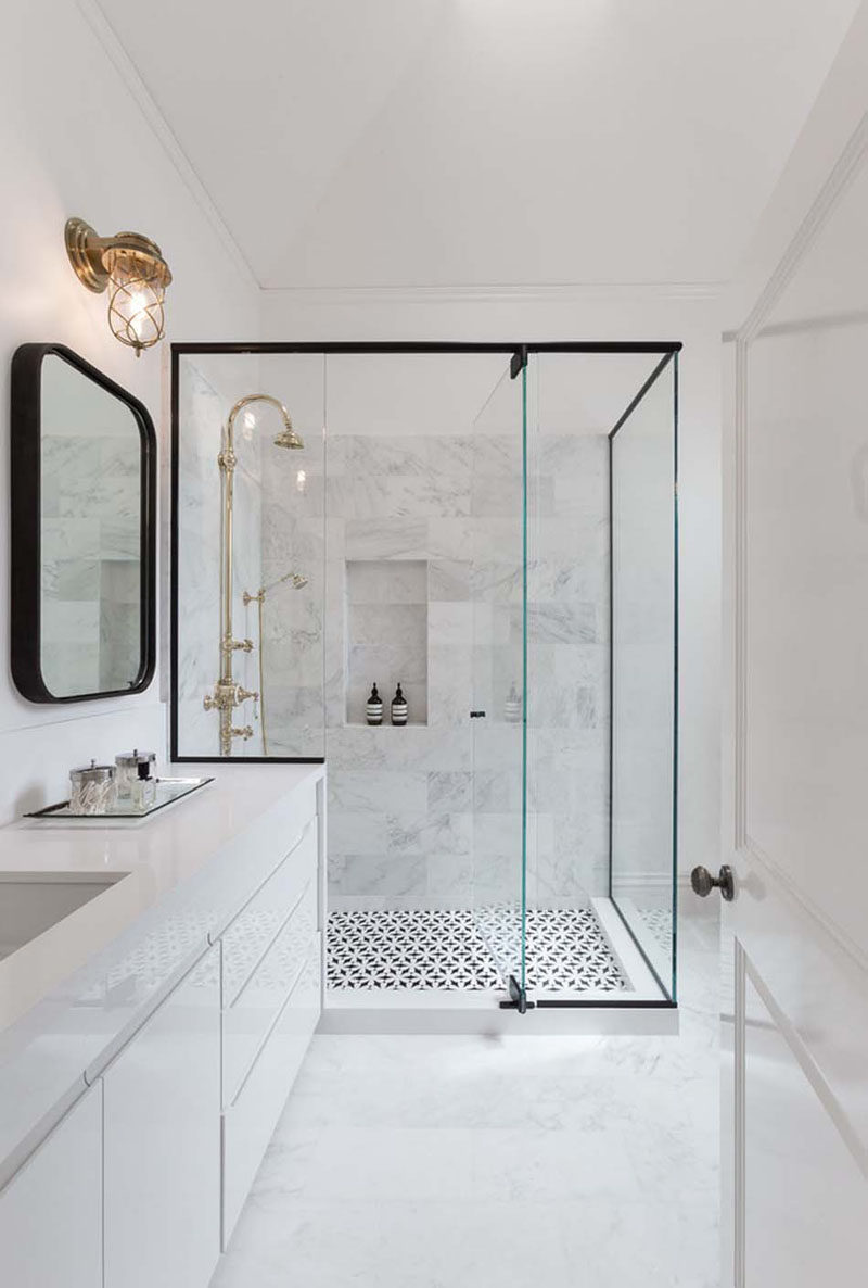 Bathroom Design Ideas - Black Shower Frames // The black frame around the perimeter of the glass on this shower carries around onto the counter to clearly define the shower area and contrast the traditional looking gold hardware.