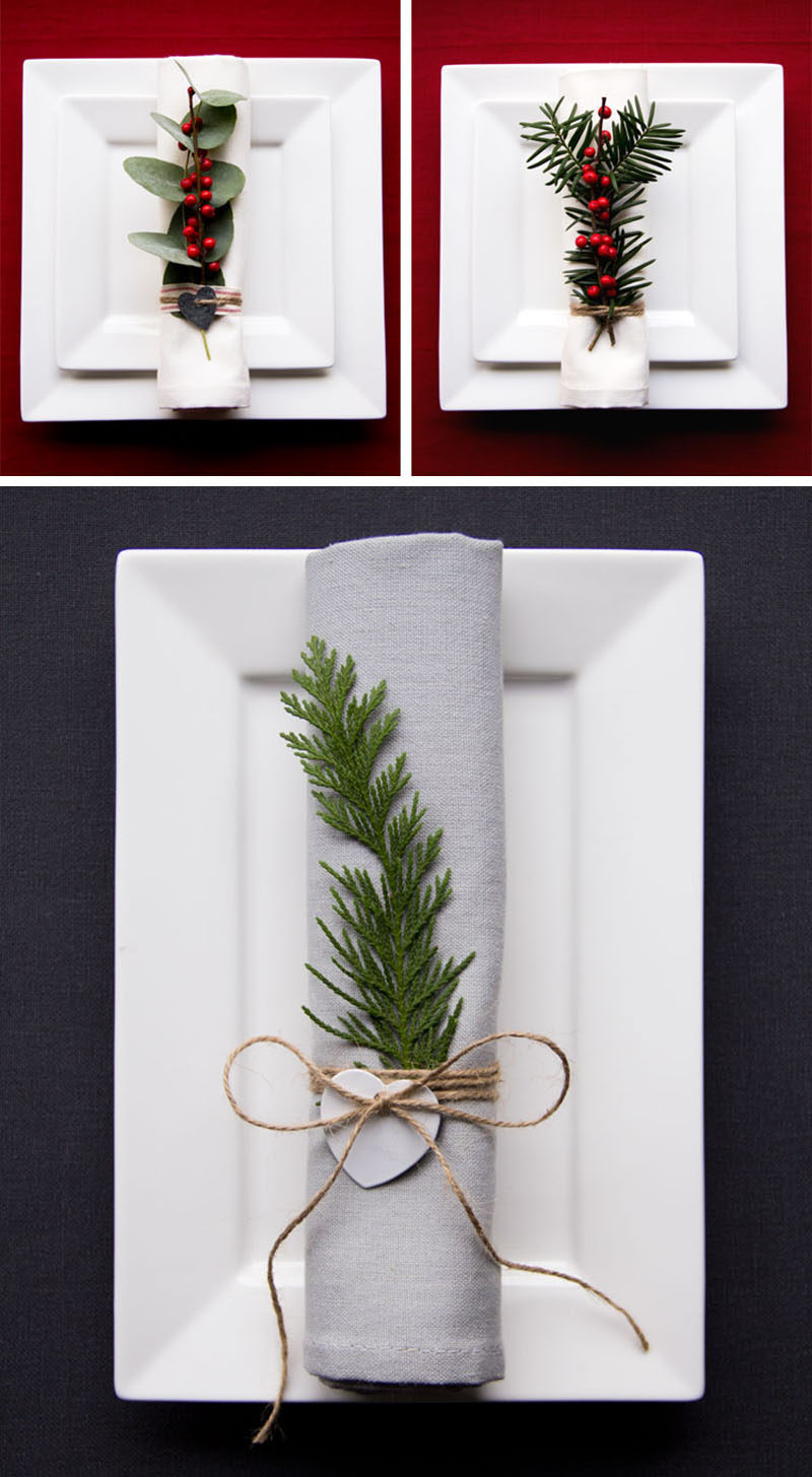 15 Inspirational Ideas For Creating A Modern Christmas Table Full Of Natural Elements // Natural greenery and berries on each napkin creates a more interesting table setting and is simple enough to make, even if you have lots of place settings to fill.