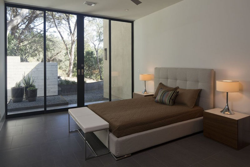 In this bedroom, large sliding glass doors can be opened to the garden outside.