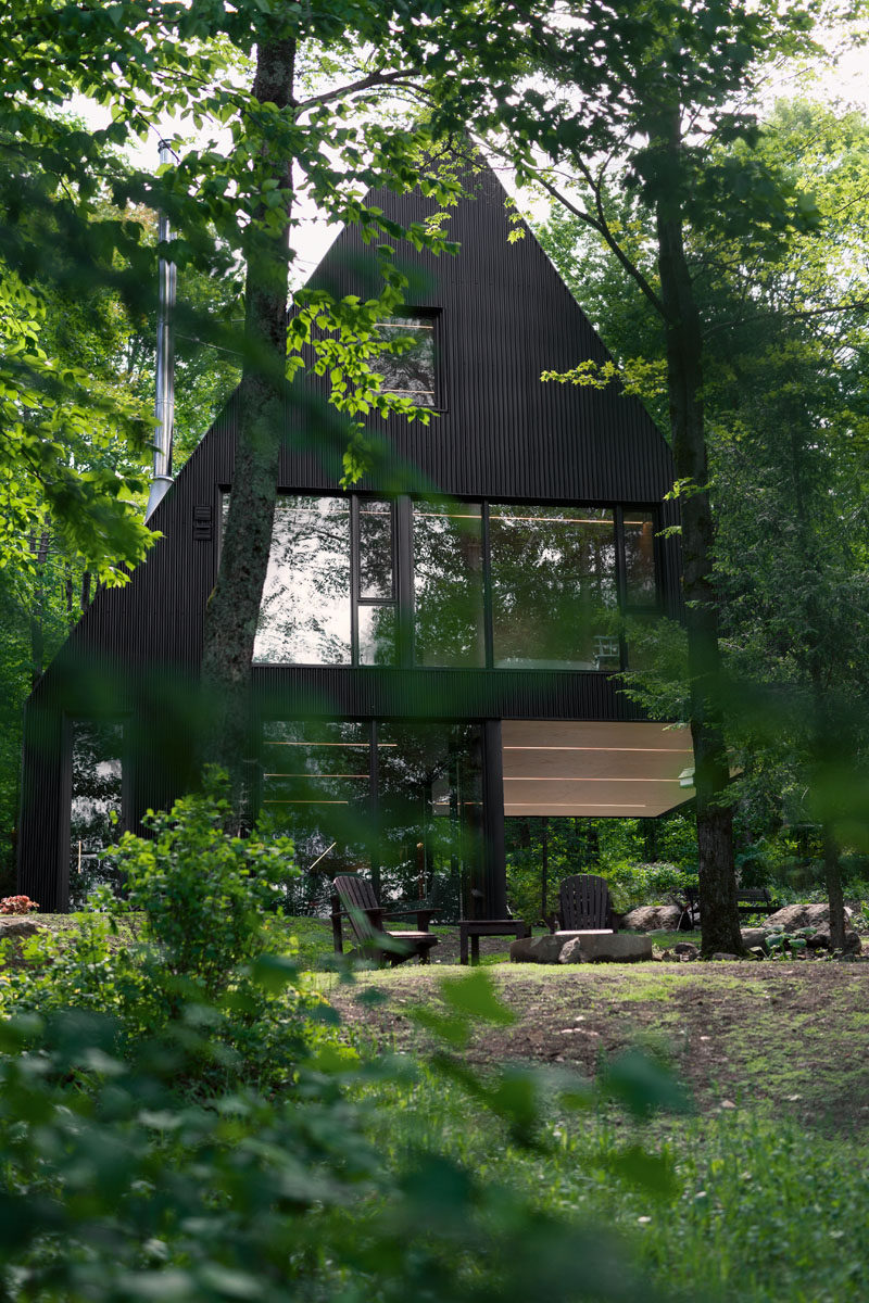 18 Modern House In The Forest // This black cabin is a summer home surrounded by a Hemlock forest in eastern Canada.