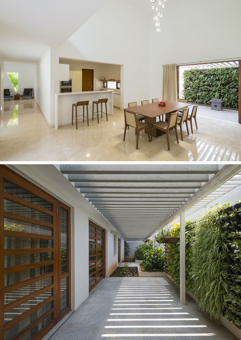 Off to the side of this dining room is an outdoor area with a green wall and pergola to provide shade.