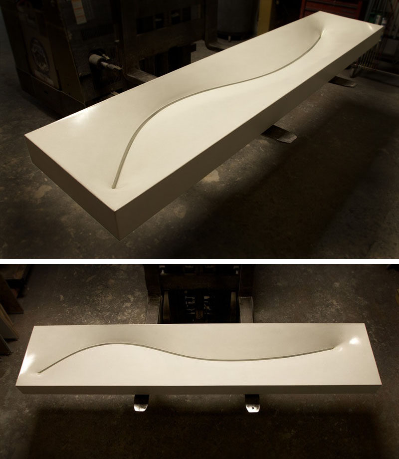 11 Creative Concrete Countertop Designs To Inspire You // A curved slot drain in this this long narrow sink gives it a smooth design and a creative drain alternative.