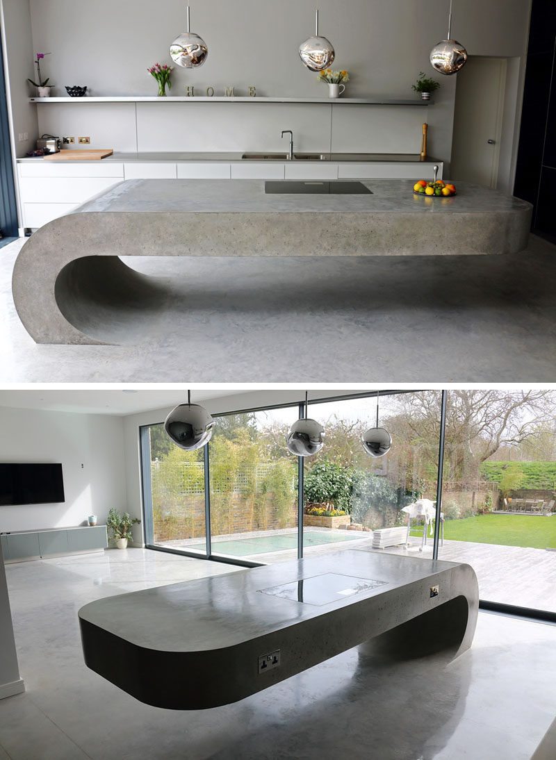 11 Creative Concrete Countertop Designs To Inspire You // This concrete kitchen island rises up out of the concrete floor and curves around in a gravity defying manner.