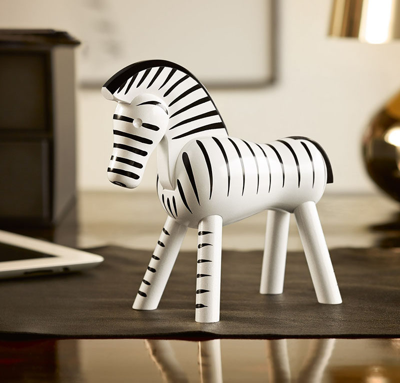 18 Decorative Animal Objects That Blur The Line Between Toys And Decor // This classic wooden zebra adds an exotic feel to your interior while keeping the space fresh looking with the simple black and white colors.