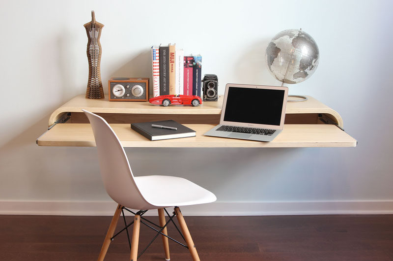 16 Wall Desk Ideas That Are Great For Small Spaces // This floating wall desk has a roll out shelf that can be pulled out when you need more room to work or left tucked in to conserve space in the room.