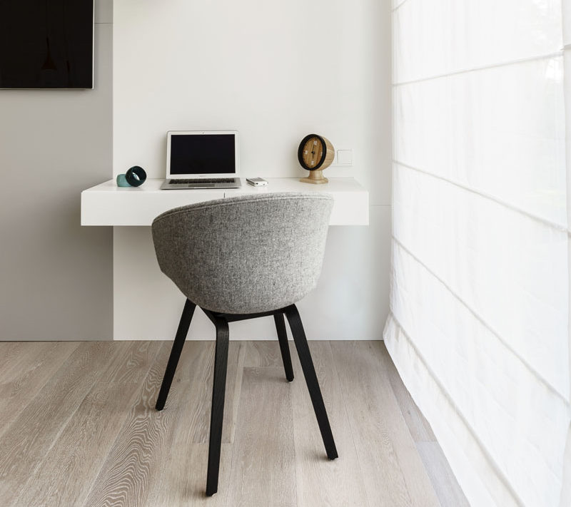 16 Wall Desk Ideas That Are Great For Small Spaces // A floating wall desk next to the window maximizes the amount of natural light you can use and puts less strain on your eyes.