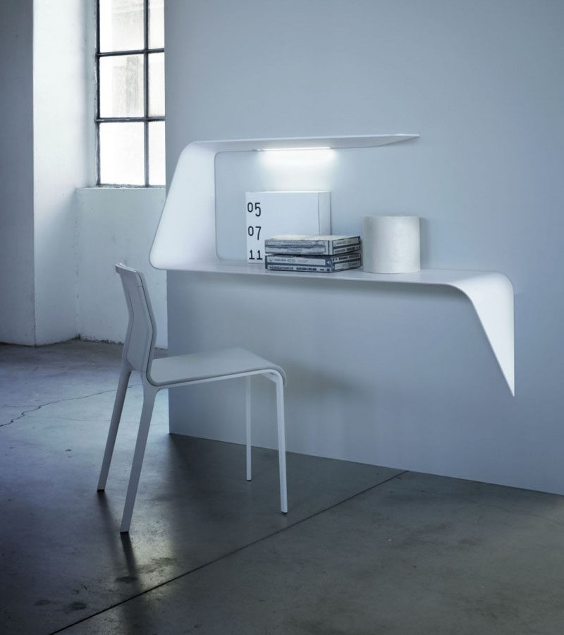 16 Wall Desk Ideas That Are Great For Small Spaces // This curved floating shelf has a light that shines in the middle of it to perfectly illuminate your work area.