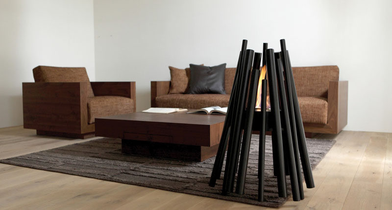 Warm Up Your Life With These 13 Freestanding Fireplace Designs // This freestanding fireplace is a modern take on the traditional pits made from a triangular arrangement of sticks and logs.