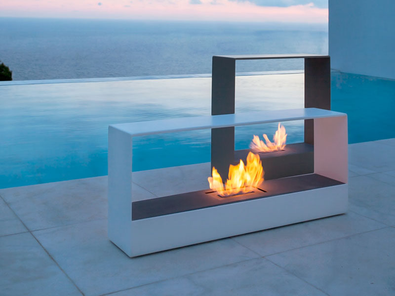 Warm Up Your Life With These 13 Freestanding Fireplace Designs // Sleek rectangular standalone fireplaces like these are the perfect addition to any outdoor set up and can be moved around to accommodate various arrangements.