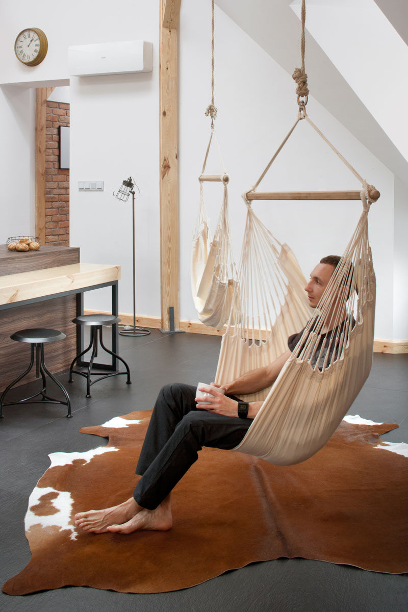 This renovated loft has a couple of hammock chairs hanging from the ceiling.