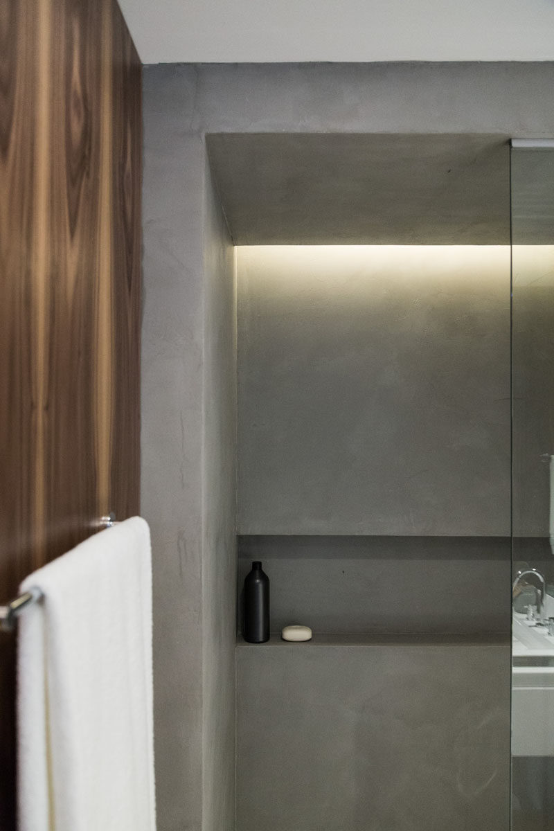 In this shower, a built-in shelf has been included in the design and hidden light provides a soft glow.