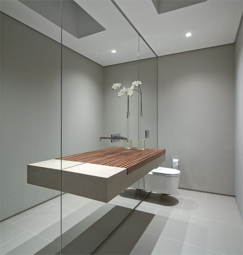 Bathroom Mirror Ideas - Fill The Wall // This wall of mirror makes the small bathroom seem much larger than it actually is and makes the sink appear to be a lot wider than it really is.