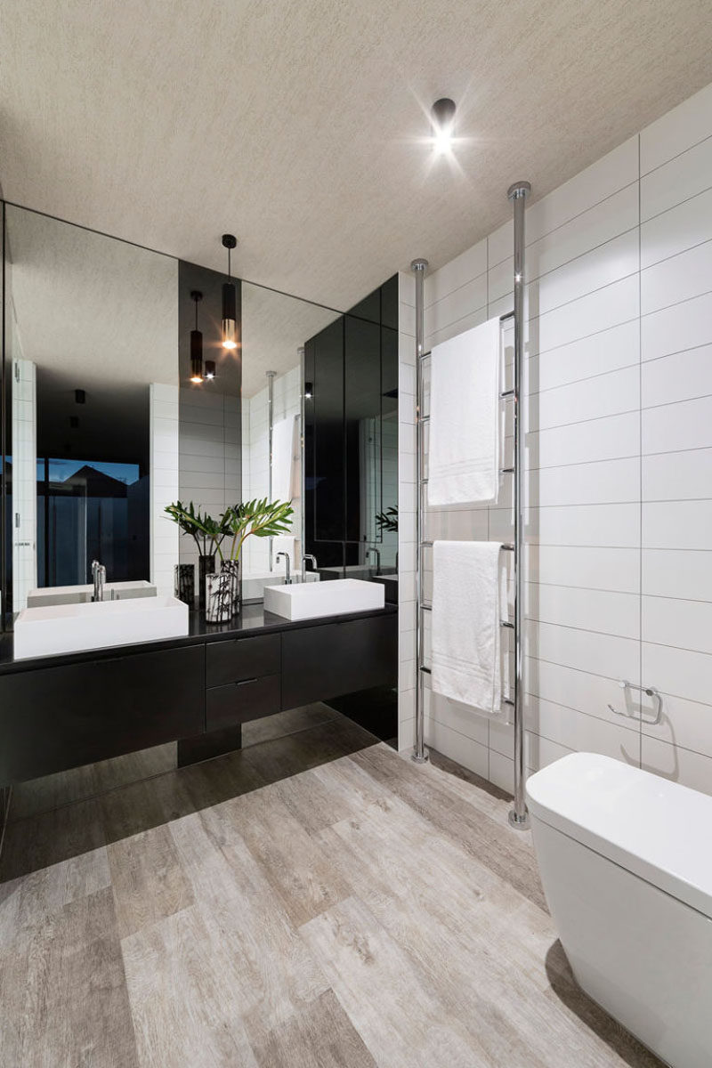 Bathroom Mirror Ideas - Fill The Wall // At first glance this looks like two separate mirrors but upon further inspection you'll notice that the strip down the middle is also part of the mirror, just a little darker to divide the vanity and give each person their space.