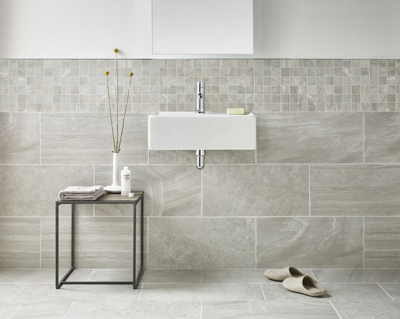 Bathroom Tile Ideas - Use Large Tiles On The Floor And Walls // Large tiles that flow from the floor to the wall, together with smaller wall tiles that line the bottom half of this bathroom wall, help to create a cohesive look.